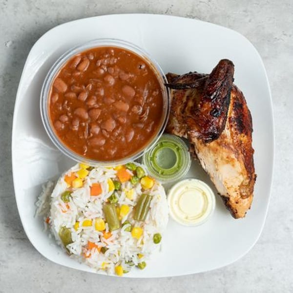 Pollo Xpress halal grilled chicken with rice, vegetables, beans, and two sauces on a white plate.